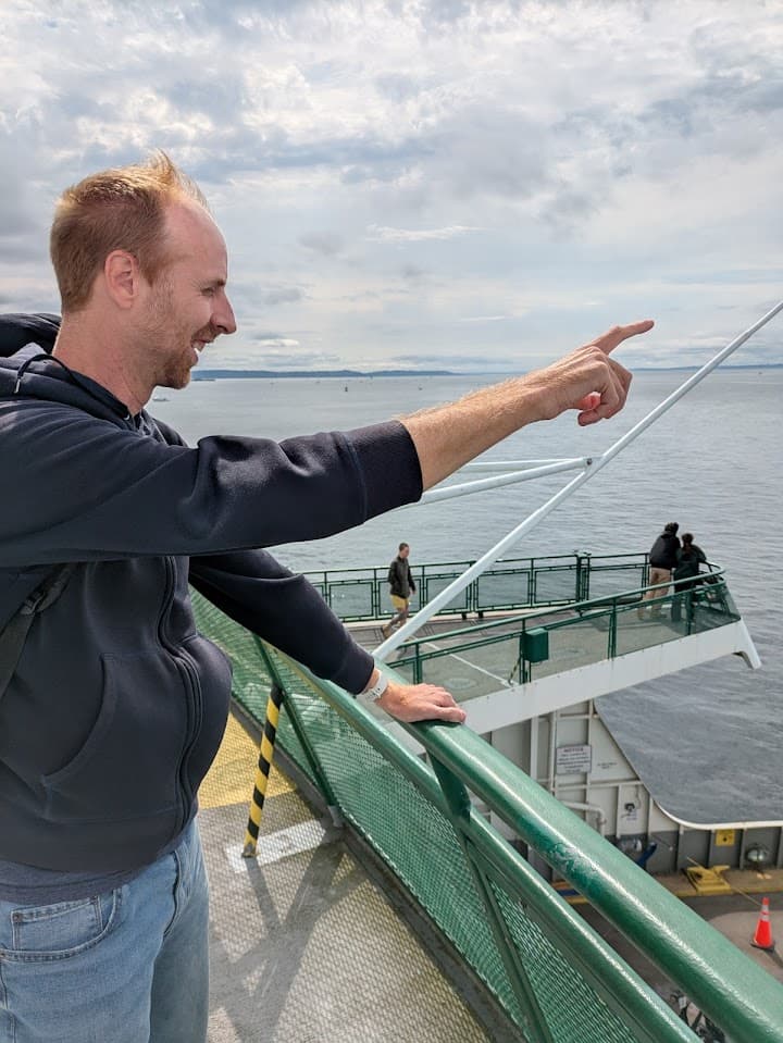 Nate pointing at something on a ferry